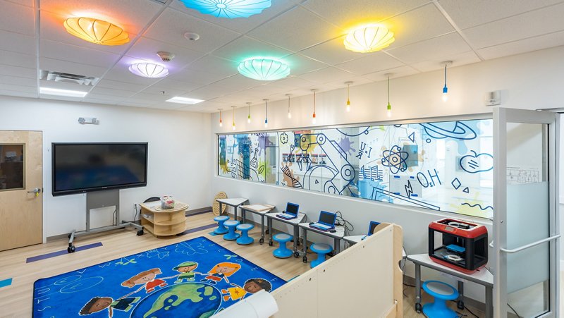 Modern STEM classroom with colorful ceiling lights and technology